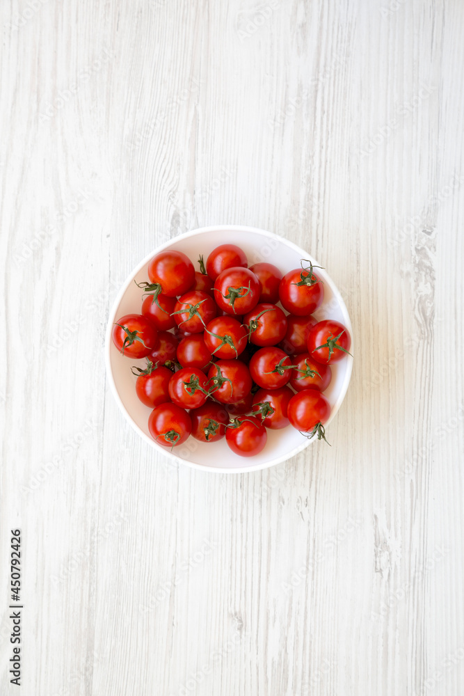 Fresh Red Organic Cherry Tomatoes in a Bowl, top view. Flat lay, overhead, from above. Fresh Red Organic Cherry Tomatoes in a Bowl, top view. Flat lay, overhead, from above.