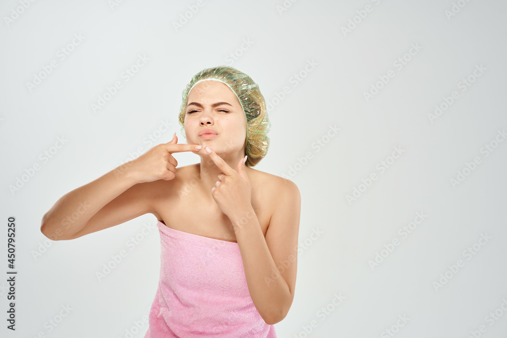 woman in pink towel and squeezes pimples on her face woman in pink towel and squeezes pimples on her face