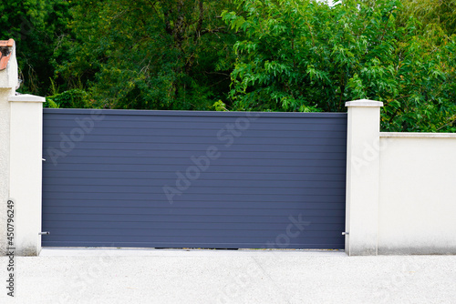 Aluminum grey steel sliding gray metal slide gate of modern suburb house entrance