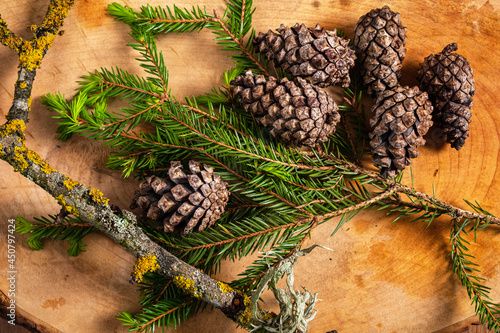 cones and fir branches on the wooden background