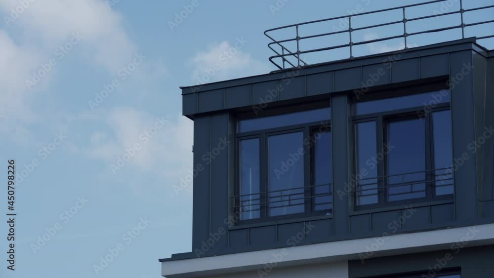 Exterior of attic floor of new multi-storey apartment building against the sky. High quality 4k footage Exterior of attic floor of new multi-storey apartment building against the sky. High quality 4k footage