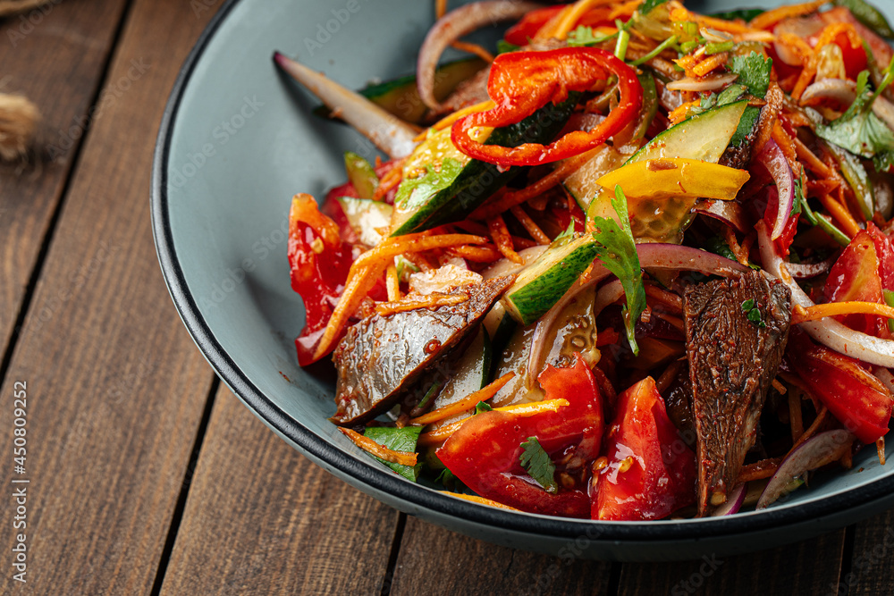 Chinese warm beef salad with vegetables and sesame seeds Chinese warm beef salad with vegetables and sesame seeds