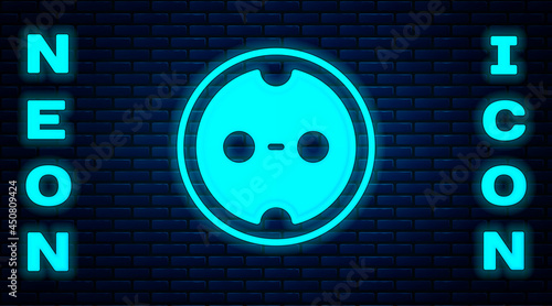 Glowing neon Electrical outlet icon isolated on brick wall background. Power socket. Rosette symbol. Vector