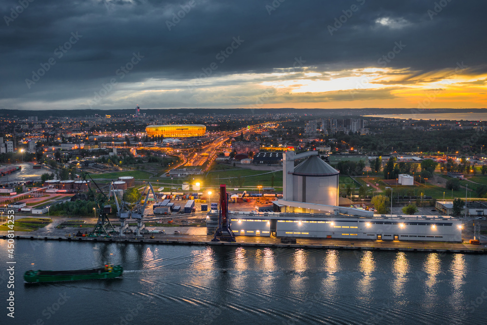The port scenery of the Martwa Wisla and illuminated stadium in Gdansk at sunset. Poland.