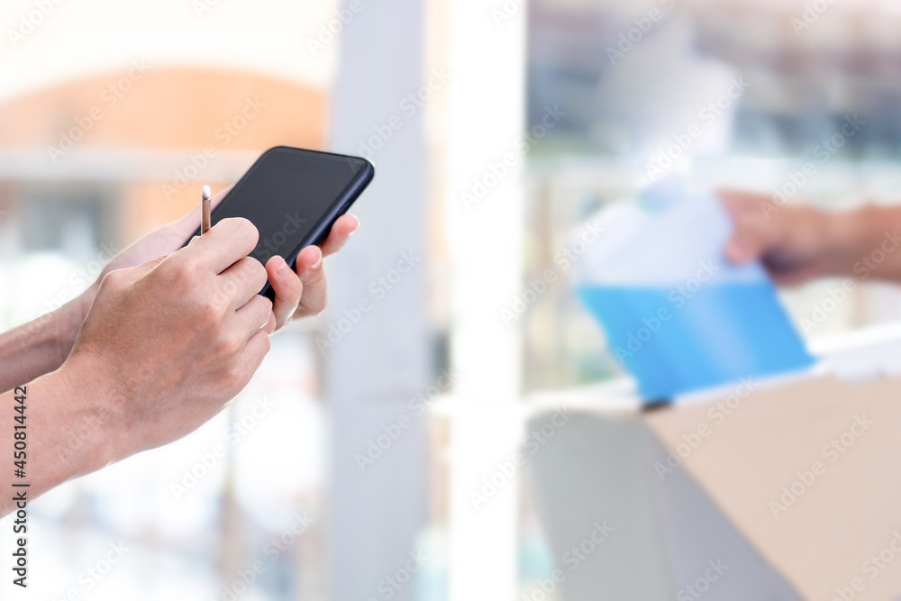 Women use electronic pen Sign and check list on smartphone after check pick up Alcohols ethanol spray from the post office transport stay at home concept Women use electronic pen Sign and check list on smartphone after check pick up Alcohols ethanol spray from the post office transport stay at home concept