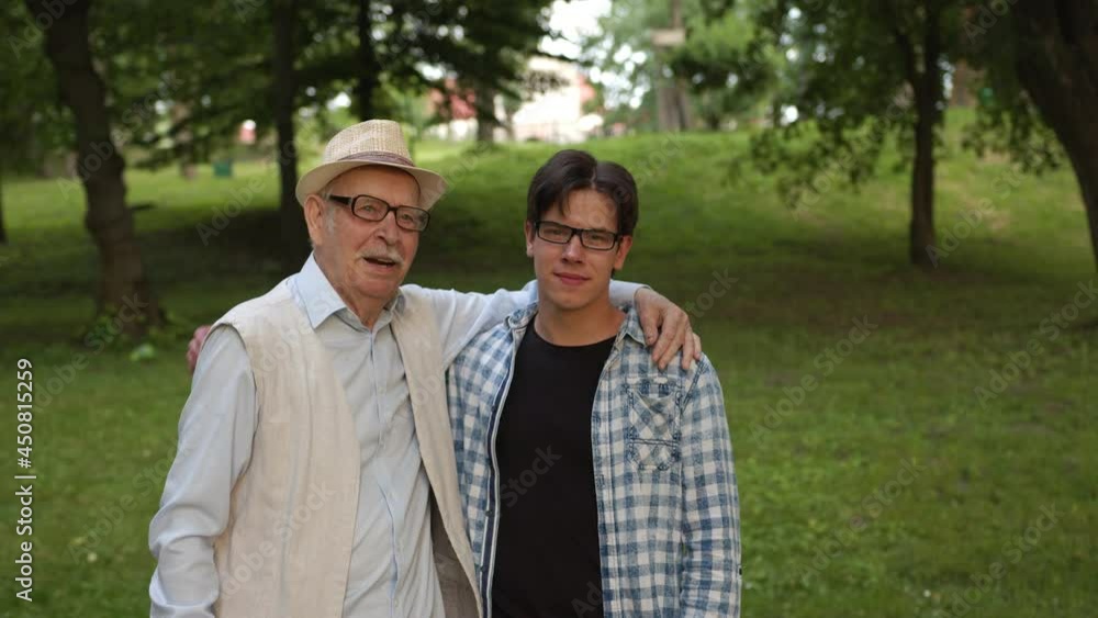 Joyful grandfather hugs his grandson and tells him about life Joyful grandfather hugs his grandson and tells him about life