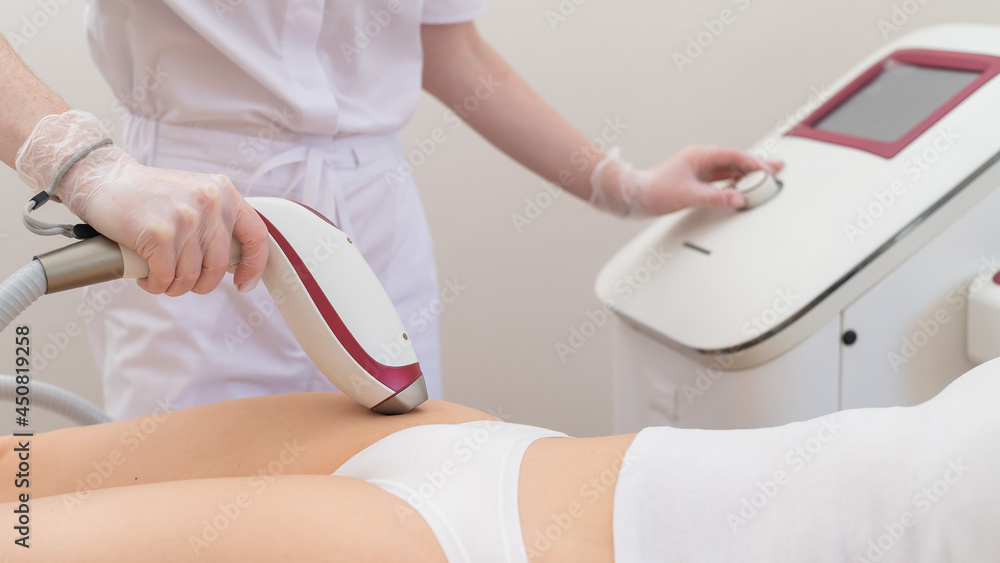 A woman in a professional beauty salon removes unwanted vegetation in the bikini area using laser hair removal A woman in a professional beauty salon removes unwanted vegetation in the bikini area using laser hair removal
