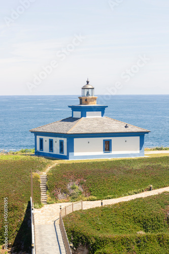 Nice view of the lighthouse of the town of Ribadeo during the day, as one of the most touristic natural environments of Gallicia, vertical shot.