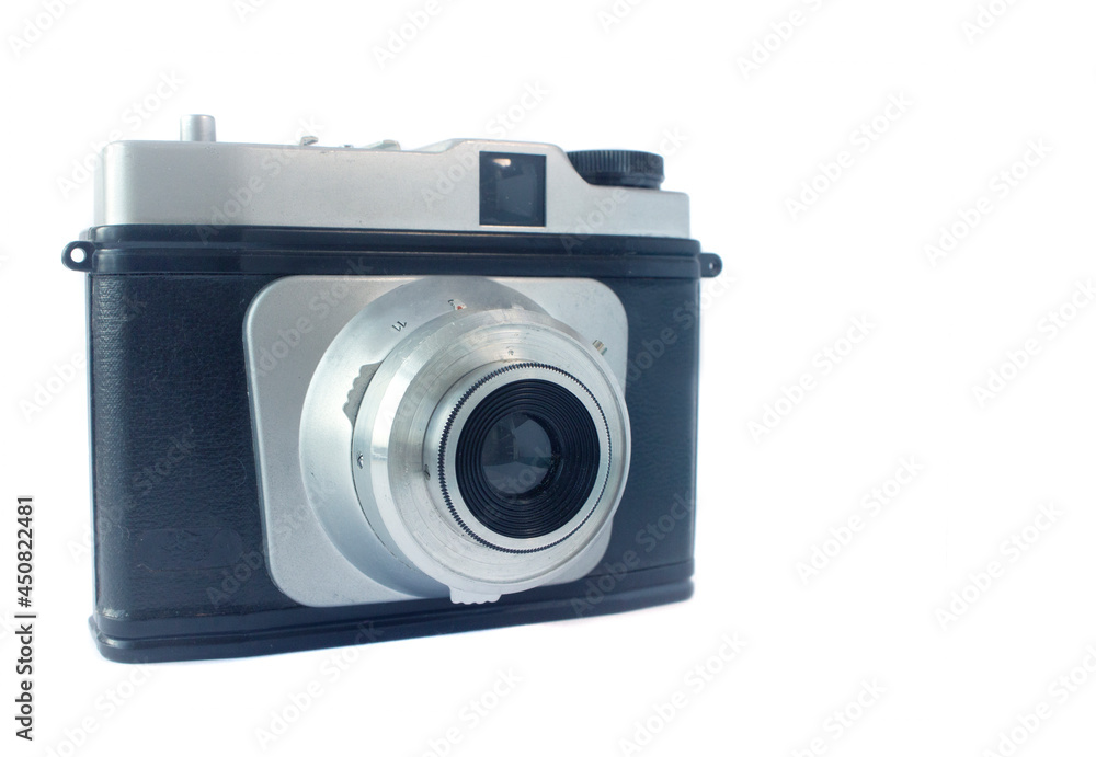 Old camera on a white background half-sided with an open lens