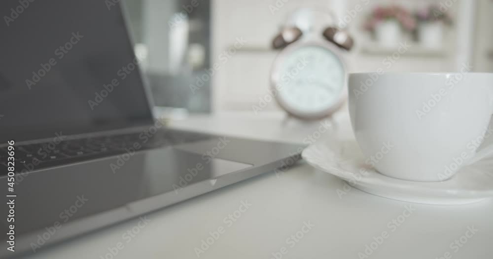 Working from home, WFH concept : A Cup of hot americano coffee, a laptop on a table. Work from home also called remote working, distance working, telework, remote job, mobile work, work from anywhere Working from home, WFH concept : A Cup of hot americano coffee, a laptop on a table. Work from home also called remote working, distance working, telework, remote job, mobile work, work from anywhere