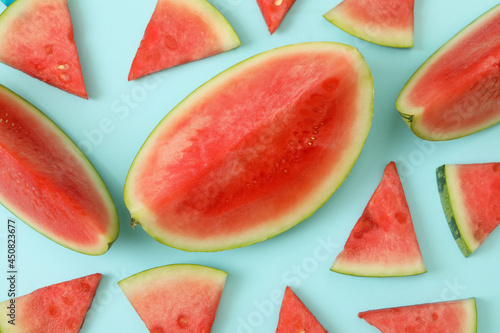 Ripe watermelon slices on blue background, top view