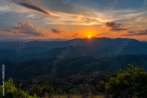Beautiful scenery of different layer of mountains and sun is going down during sunset time. Taken at Betong district  Yala province in Thailand.
