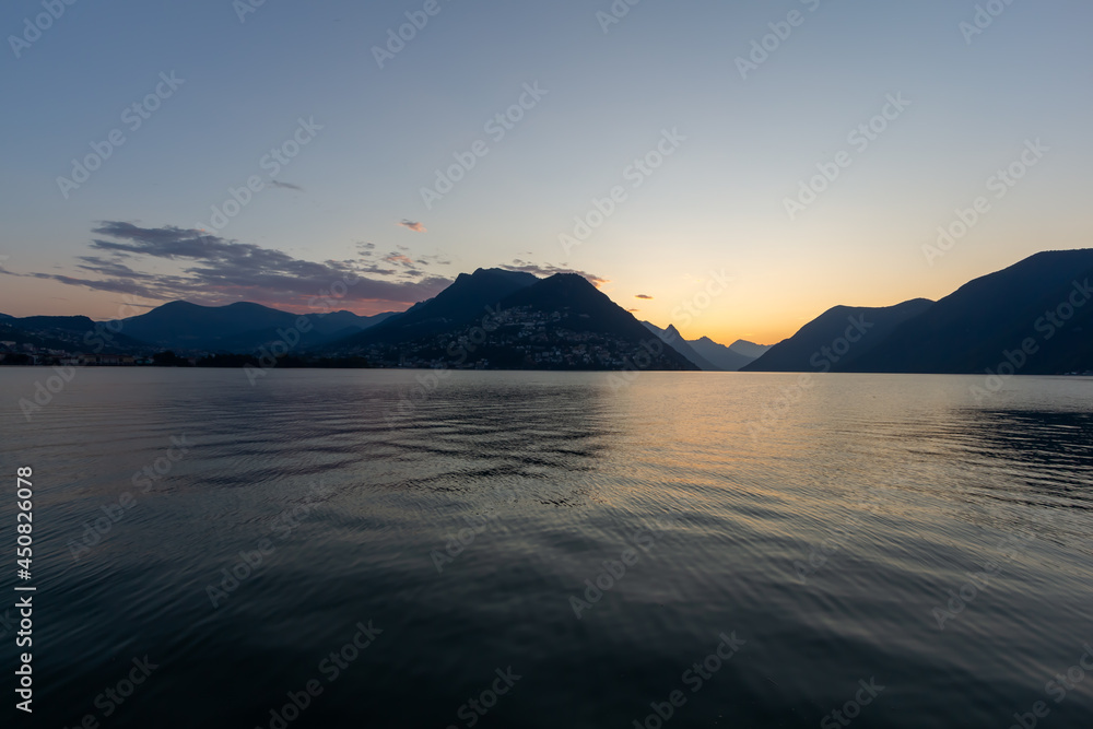 Panoramic view at sunrise time with hills on the lake Lugano, Paradiso, Switzerland