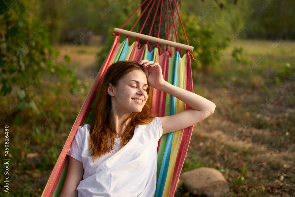 Fototapeta premium cheerful woman lies in a hammock in nature sun rest
