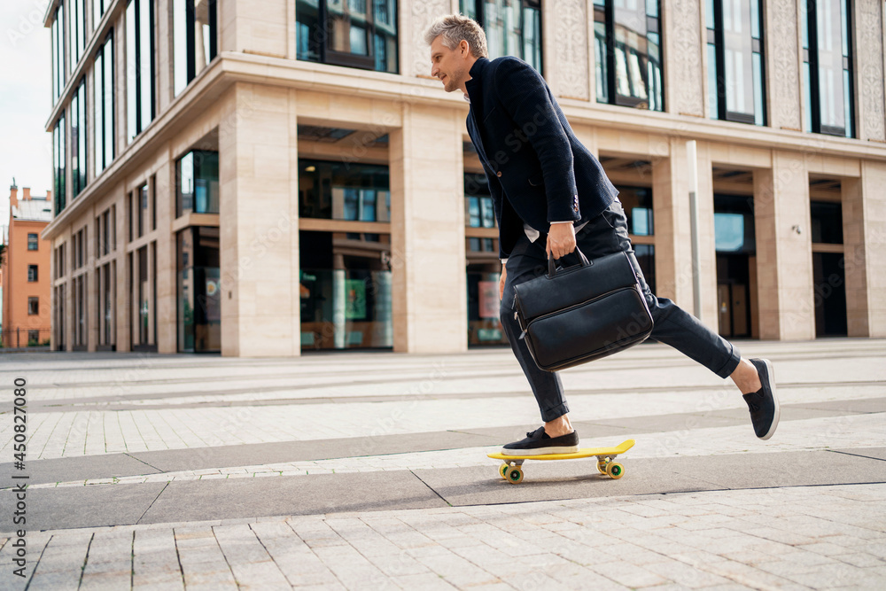 The manager is rushing to a meeting in a business suit. An entrepreneur rides a skateboard to work in the morning. The lawyer holds a bag with documents in his hand.