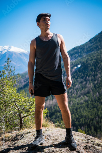 Handsome fit young man hiking at mountain
