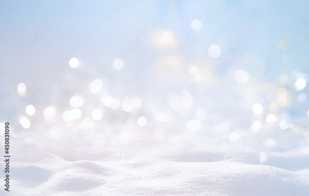 Festive Christmas natural snowy background, abstract empty stage, snow, snowdrift and defocused Christmas lights on light blue background, copy space.