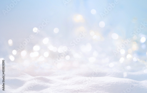 Festive Christmas natural snowy background, abstract empty stage, snow, snowdrift and defocused Christmas lights on light blue background, copy space. © Laura Pashkevich