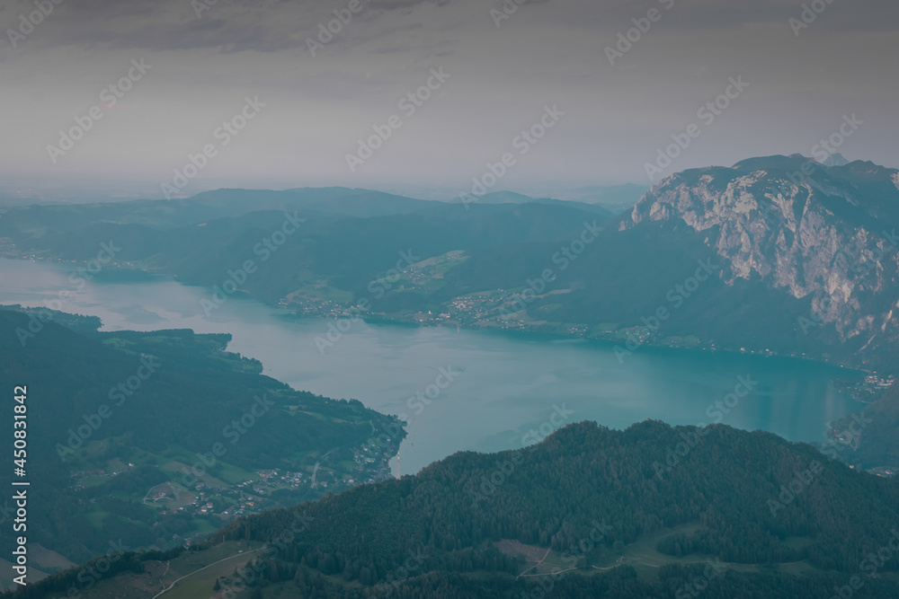 View from the top of Schafberg mountain looking down towards Attersee and other lakes of upper Austria during a beautiful summer sunset. View from the top of Schafberg mountain looking down towards Attersee and other lakes of upper Austria during a beautiful summer sunset.