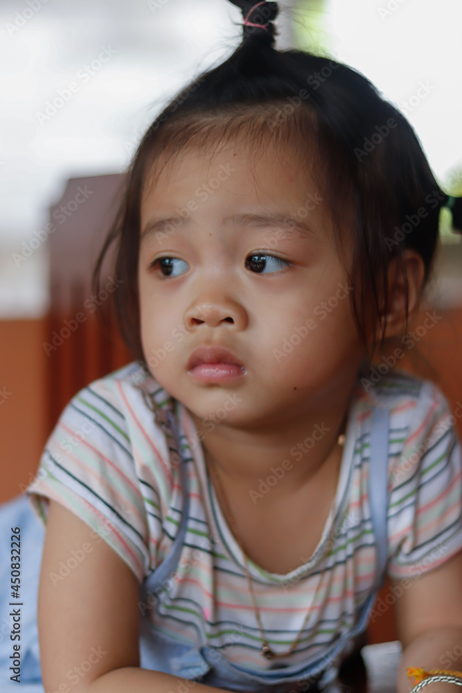 A headshot portrait of a cheerful baby Asian woman A headshot portrait of a cheerful baby Asian woman