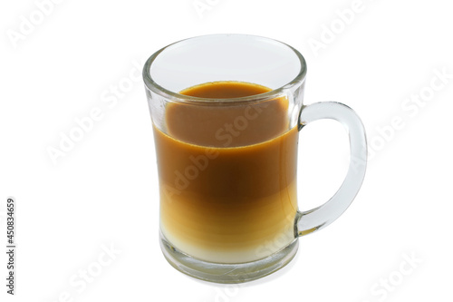 Two layers of milk coffee in a transparent glass, perspective view,  isolated on a white background