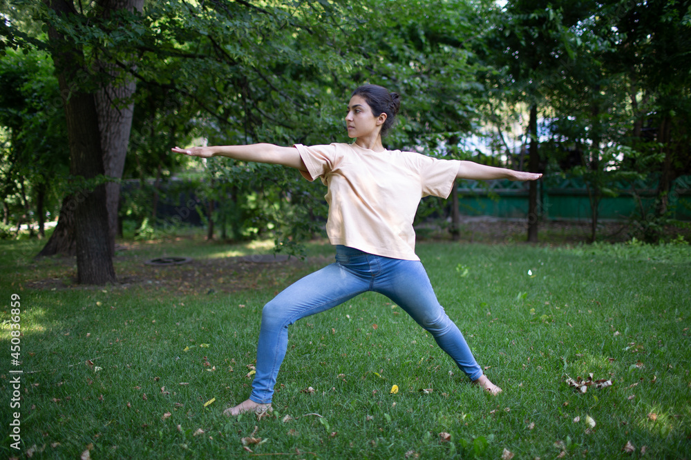 Indian woman doing yoga in outdoor summer park. Indian woman doing yoga in outdoor summer park.