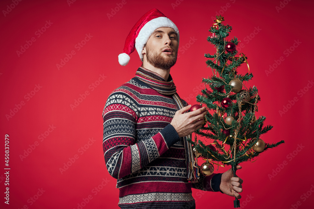 man in New Year's clothes Christmas tree in hands toys holiday emotions man in New Year's clothes Christmas tree in hands toys holiday emotions