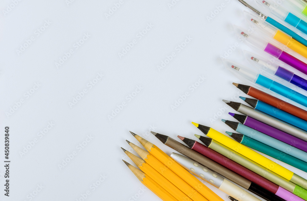 A different colored stationery in stands on a variety school supplies