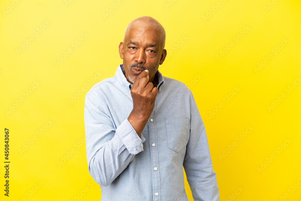 Cuban Senior isolated on yellow background showing a sign of silence gesture Cuban Senior isolated on yellow background showing a sign of silence gesture