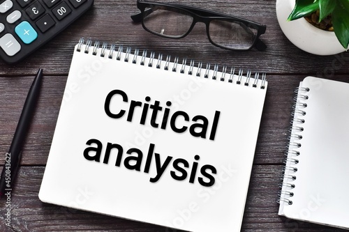 Wallpaper Mural CRITICAL ANALYSIS text on notebook with calculator, eyeglasses, green plant and pen on a wooden background. Flat lay. Torontodigital.ca