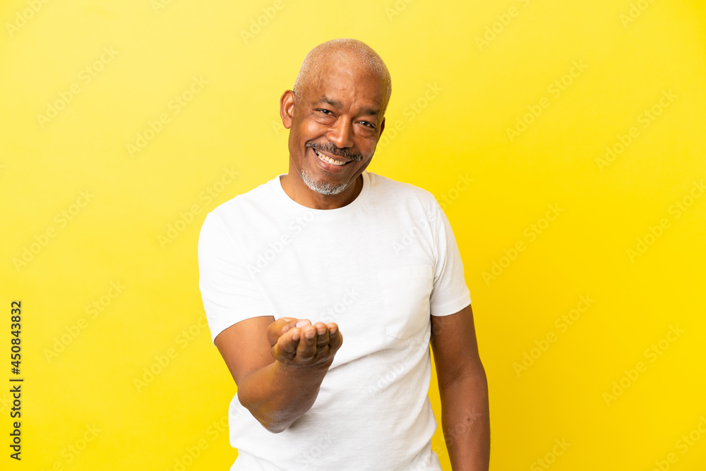 Cuban Senior isolated on yellow background inviting to come with hand. Happy that you came Cuban Senior isolated on yellow background inviting to come with hand. Happy that you came