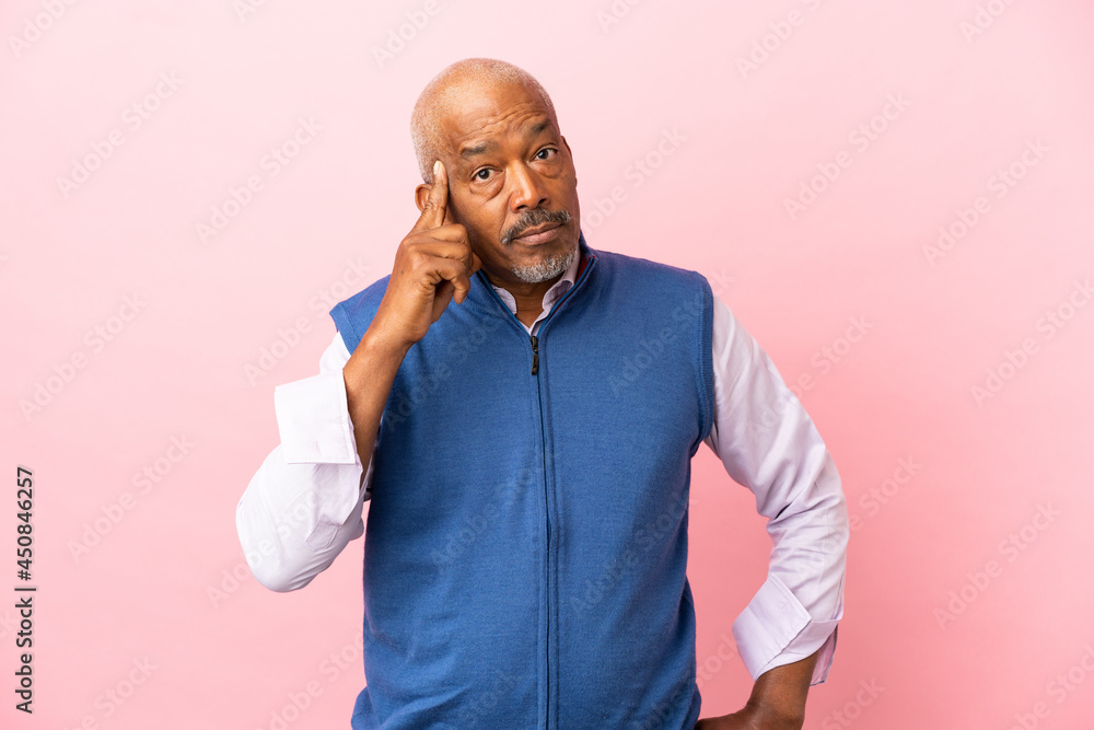 Cuban senior isolated on pink background thinking an idea Cuban senior isolated on pink background thinking an idea