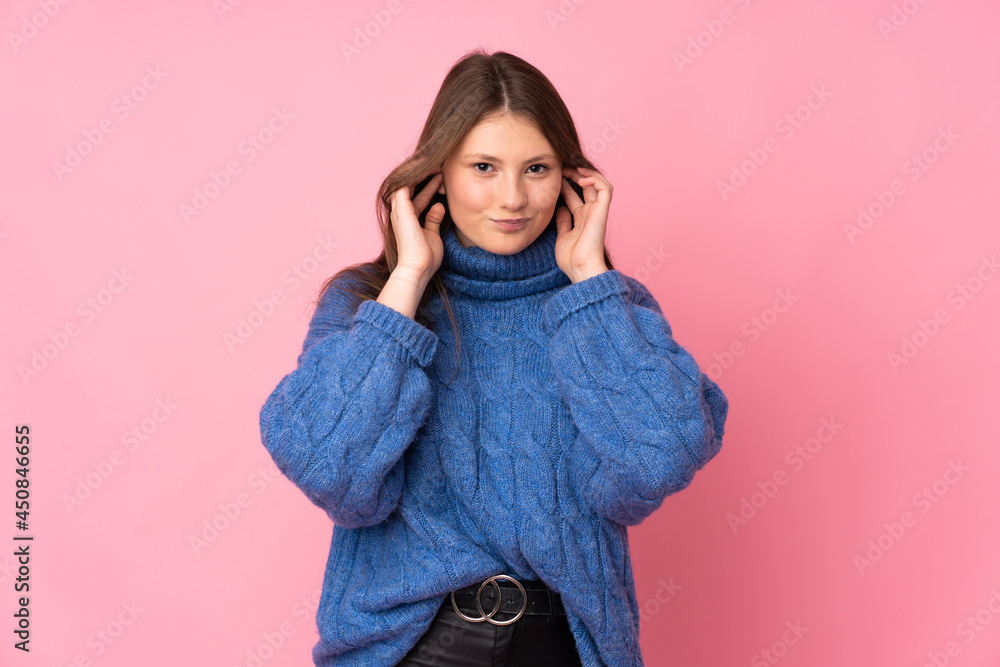 Teenager caucasian girl isolated on pink background frustrated and covering ears Teenager caucasian girl isolated on pink background frustrated and covering ears