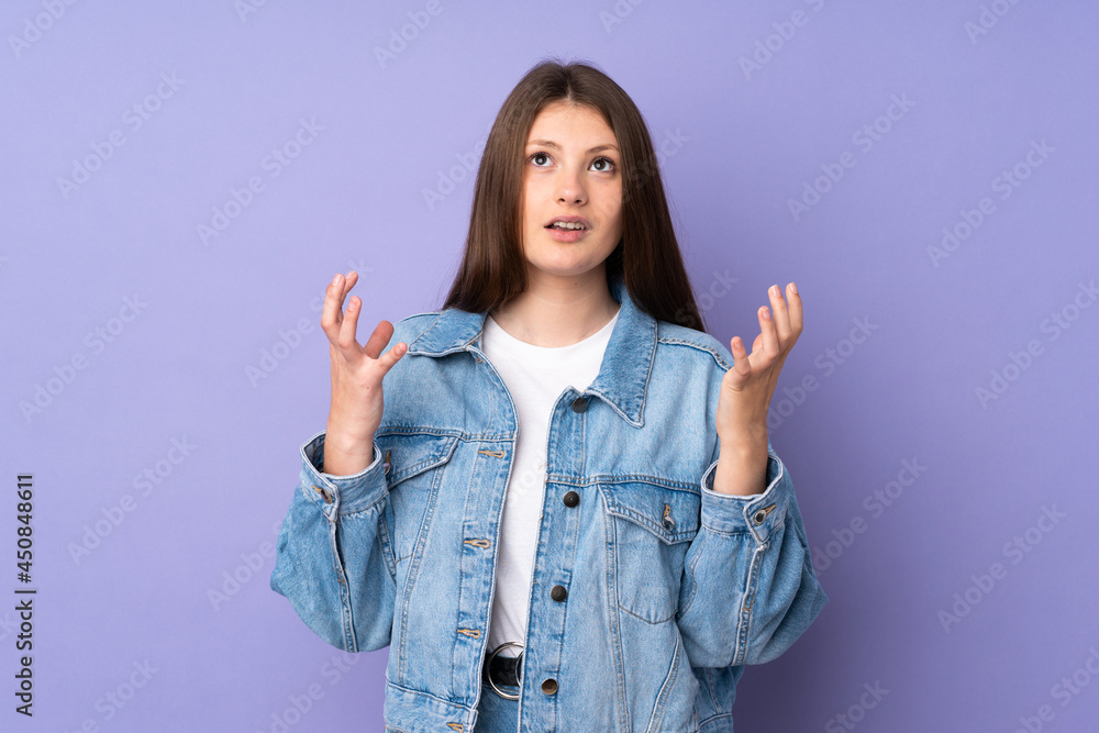 Teenager caucasian girl isolated on purple background stressed overwhelmed