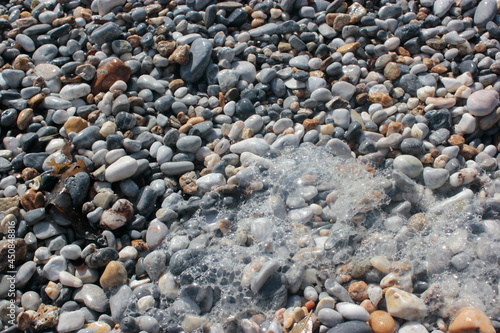Lots of bubbles on the beach pebbles