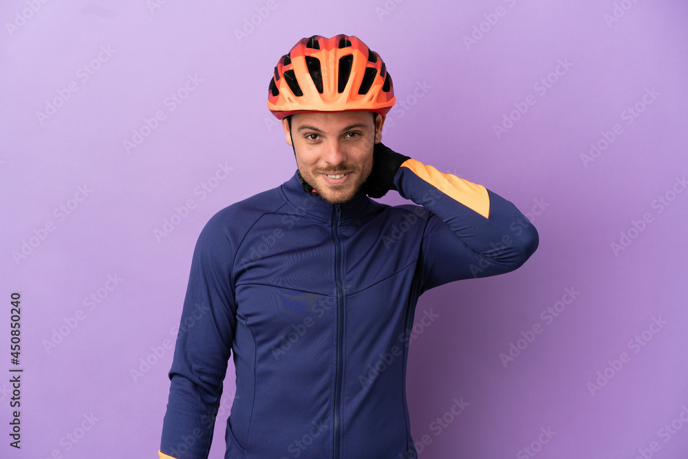 Young Brazilian cyclist man isolated on purple background laughing Young Brazilian cyclist man isolated on purple background laughing