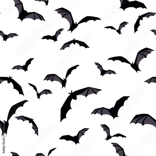 Vector Halloween seamless background with flying bats on white.