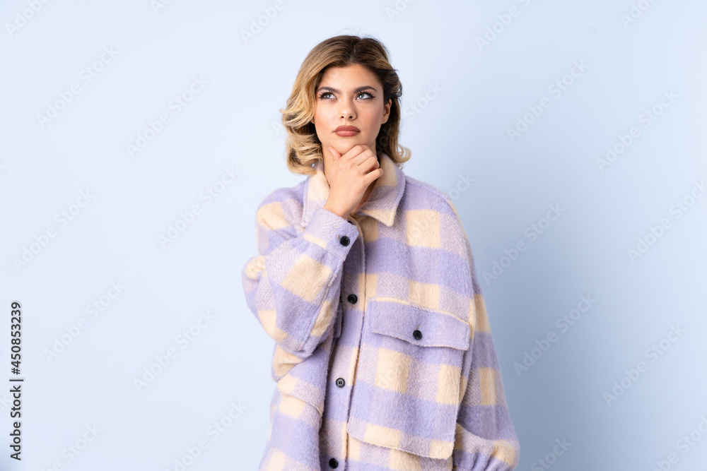 Young Russian woman isolated on blue background thinking Young Russian woman isolated on blue background thinking
