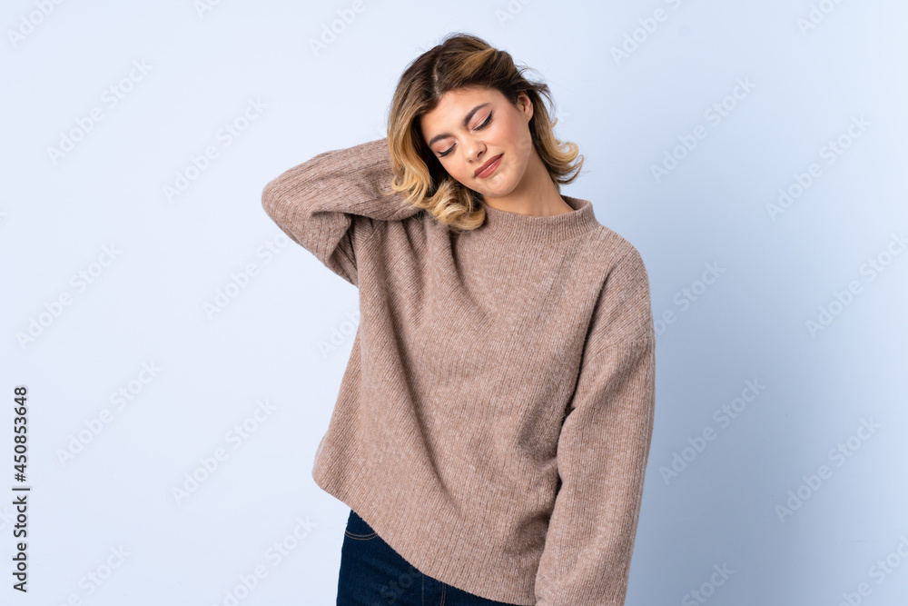 Young Russian woman isolated on blue background with neckache Young Russian woman isolated on blue background with neckache
