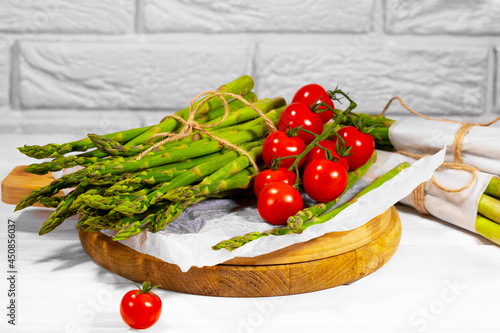 Asparagus and Tomato. Fresh harvest, traditional italian cuisine and foods. Healthy vegetarian food. Fresh raw organic vegetables, market. Vegan backdrop