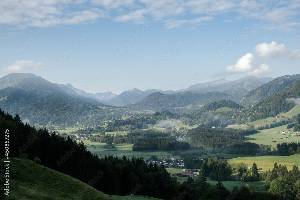 view to the cloudy valley near Oberstdorf in the morning with the Allgäu mountains Ifen in the background.