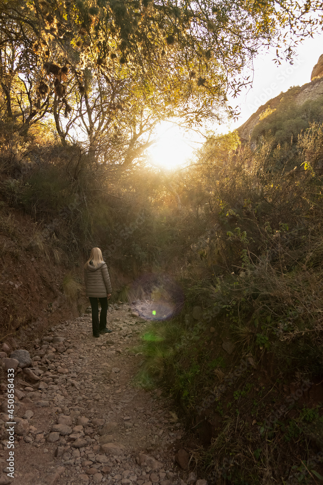 woman walking on the mountain in the sunlight