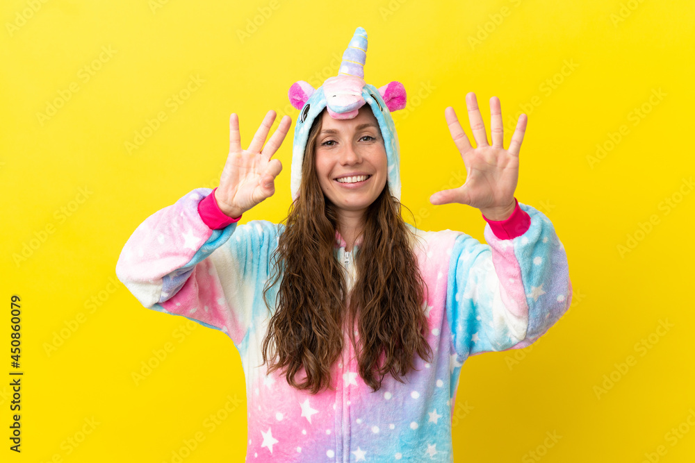 Girl with unicorn pajamas over isolated background counting eight with fingers Girl with unicorn pajamas over isolated background counting eight with fingers