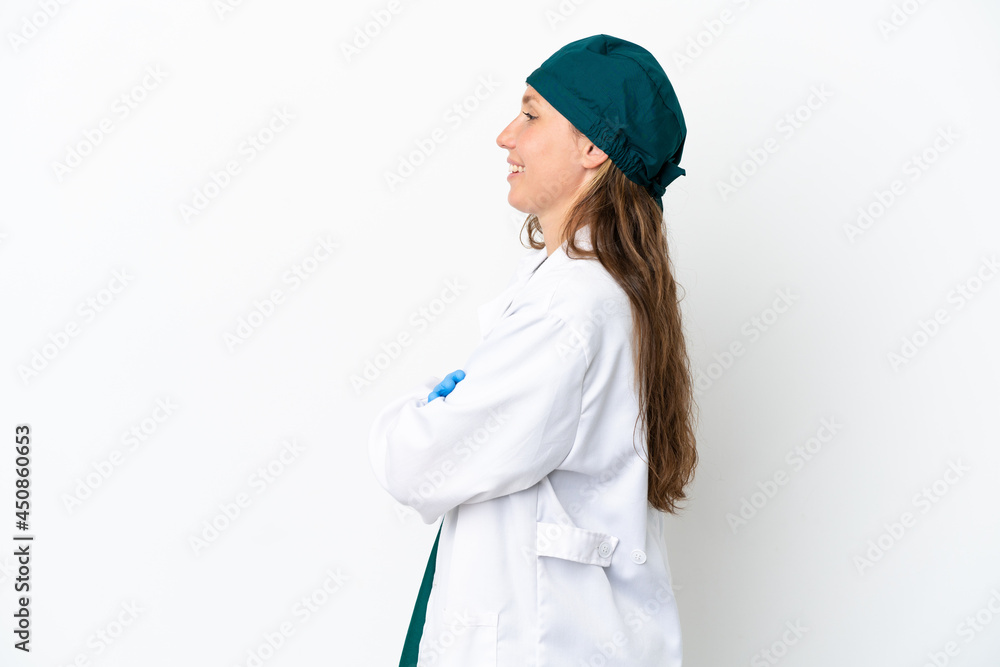 Surgeon caucasian woman in green uniform isolated on white background in lateral position Surgeon caucasian woman in green uniform isolated on white background in lateral position