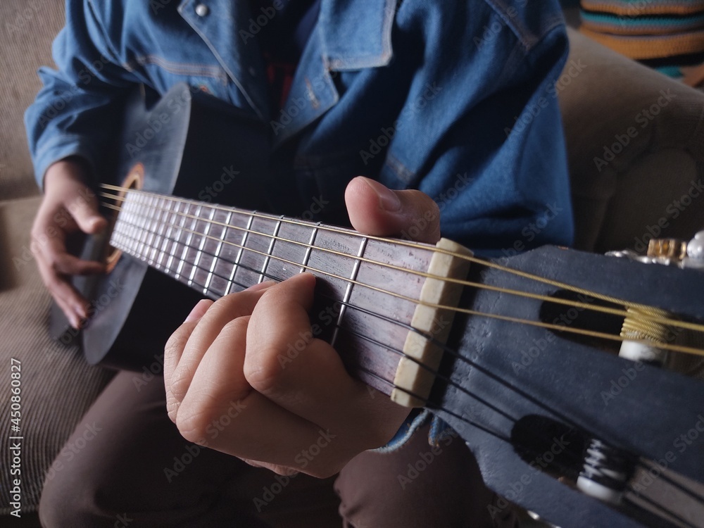 Fototapeta premium man playing black guitar