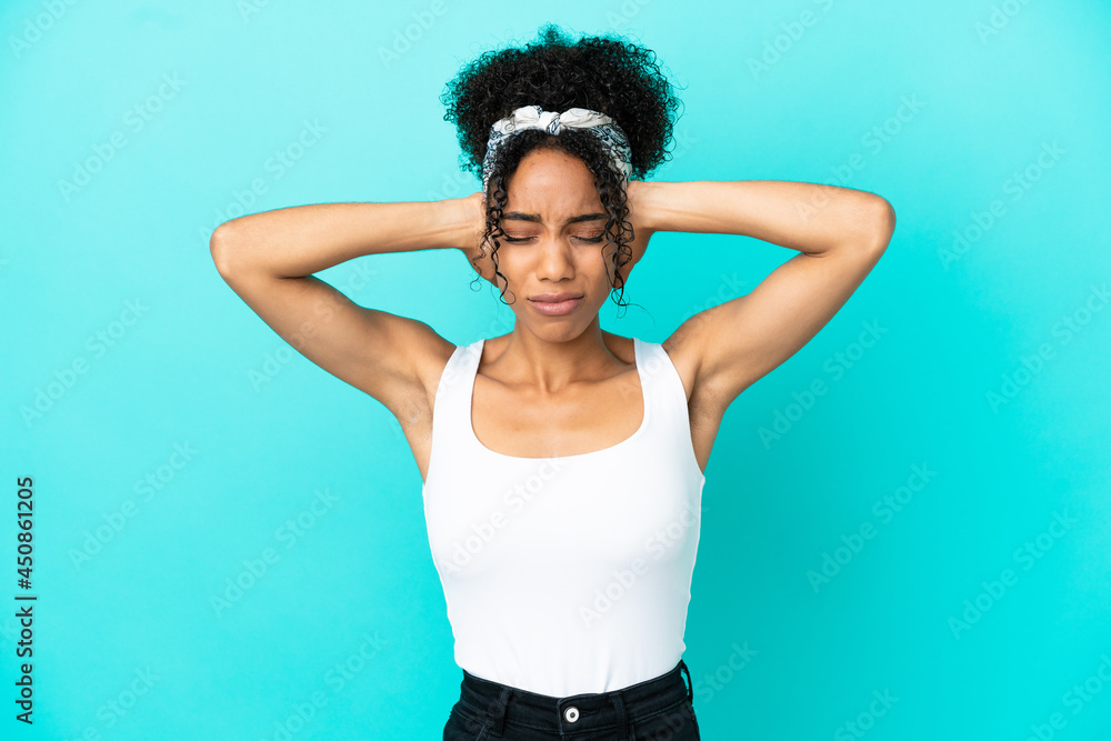 Young latin woman isolated on blue background frustrated and covering ears Young latin woman isolated on blue background frustrated and covering ears