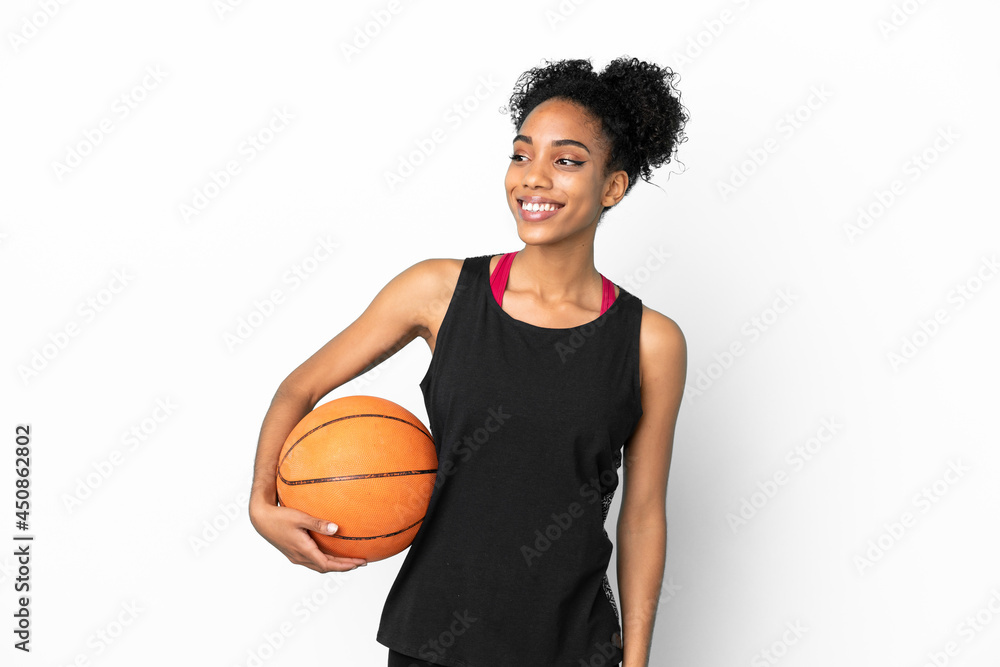 Young basketball player latin woman isolated on white background looking to the side and smiling