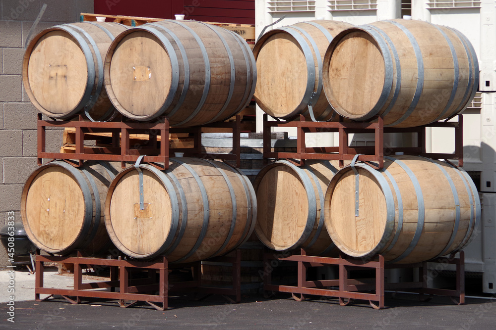 Eight oak wine barrels stacked in groups of four