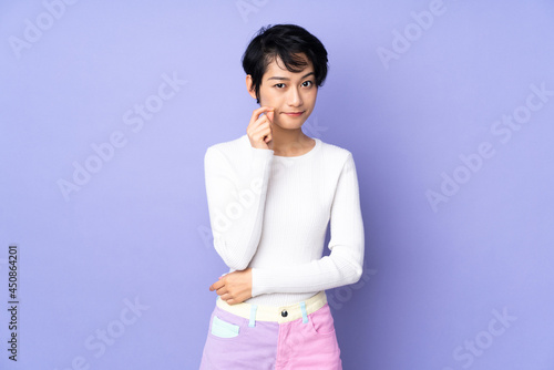 Young Vietnamese woman with short hair over isolated purple background showing a sign of silence gesture