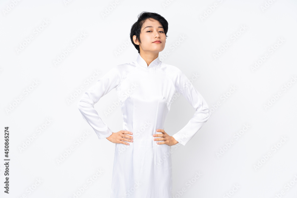 Young Vietnamese woman with short hair wearing a traditional dress over isolated white background angry Young Vietnamese woman with short hair wearing a traditional dress over isolated white background angry